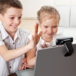 children on a video chat with family